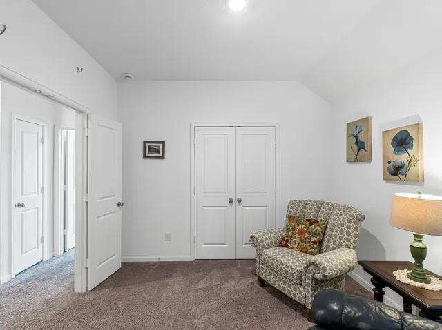 a living room with furniture and a lamp