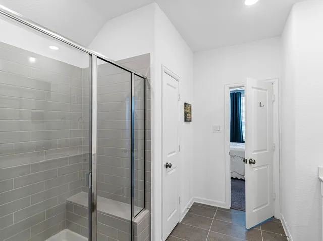 a bathroom with a shower and a sink