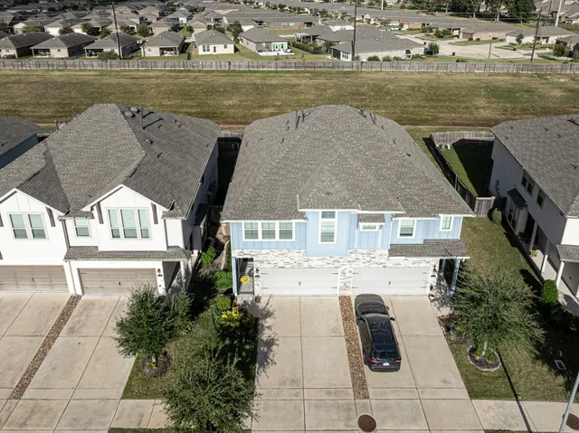 an aerial view of a house with a lake view