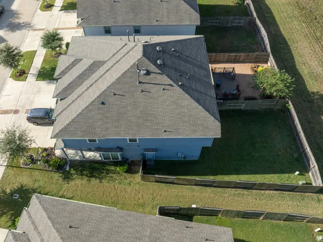 an aerial view of a house with a yard
