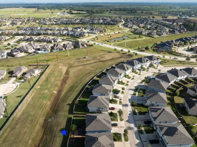an aerial view of residential houses with outdoor space