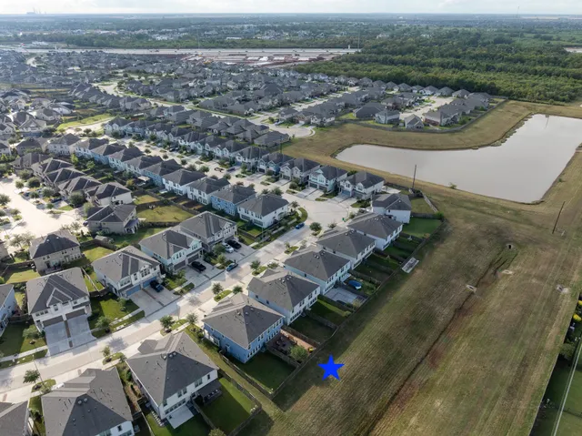 an aerial view of residential houses with outdoor space