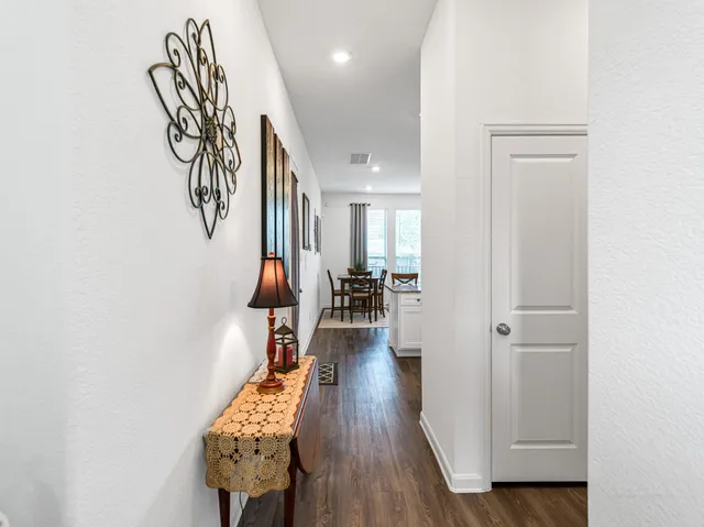 a hallway with wooden floor and furniture