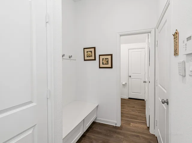a view of a hallway with wooden floor