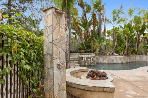 a patio with a table and chairs and a fire pit