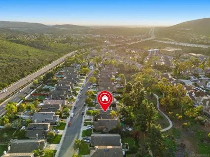 an aerial view of residential houses with outdoor space and swimming pool