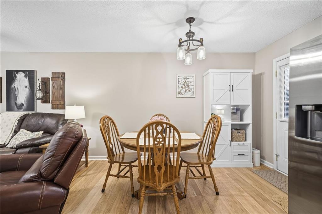 2525 Henderson Mountain Road Jasper, GA 30143 - Photo 12 of 23 a view of a dining room with furniture and chandelier