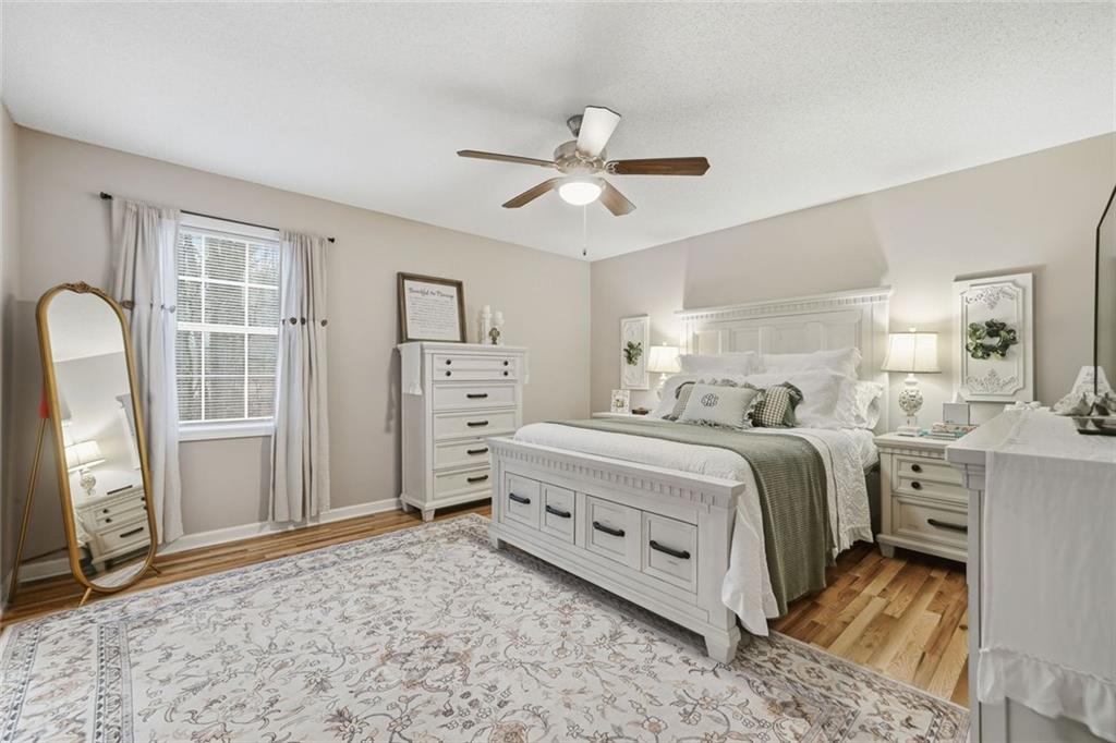2525 Henderson Mountain Road Jasper, GA 30143 - Photo 14 of 23 a spacious bedroom with a bed and a dresser