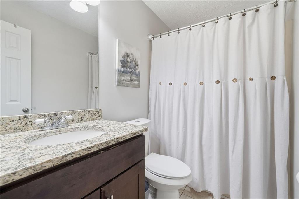 2525 Henderson Mountain Road Jasper, GA 30143 - Photo 20 of 23 a bathroom with a granite countertop sink and a mirror