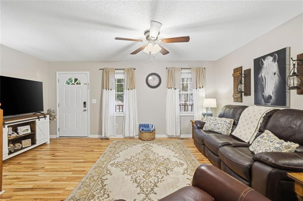 2525 Henderson Mountain Road Jasper, GA 30143 - Photo 7 of 23 a living room with furniture and a flat screen tv