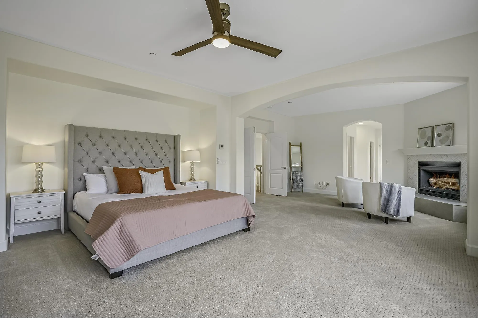 3737 Keri Way Fallbrook, CA 92028 - Photo 16 of 43 a spacious bedroom with a bed a chandelier and couch