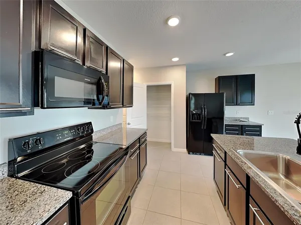 a kitchen with a sink stainless steel appliances and cabinets