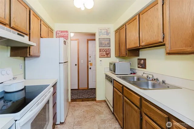 a kitchen with a sink stove and refrigerator