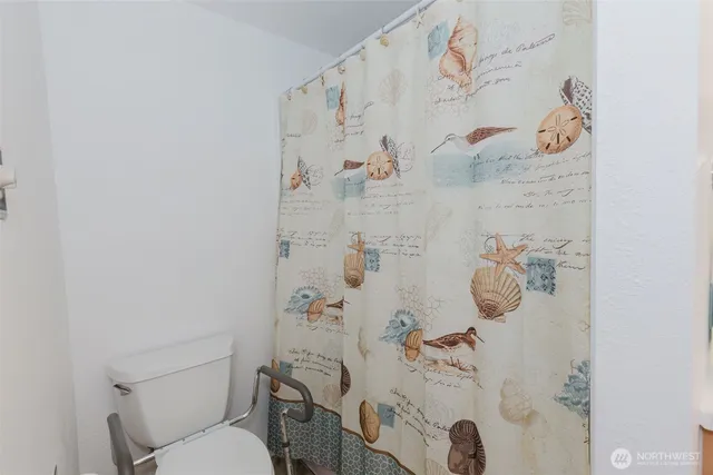 a white toilet sitting next to a bathroom sink