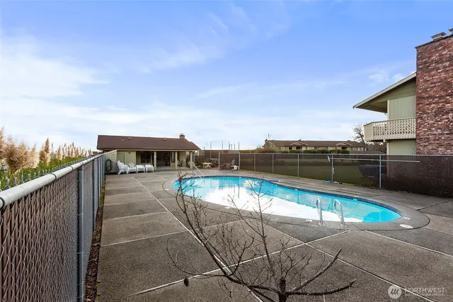 a view of a swimming pool with a lounge chair