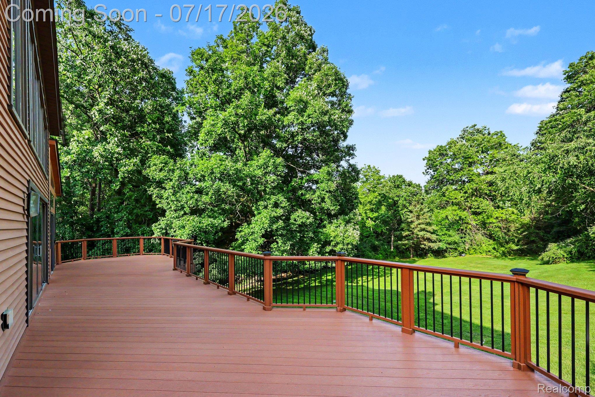 5685 Paint Valley Drive Rochester, MI 48306 - Photo 38 of 66 Expansive composite deck featuring a brown finish and a black spindle railing system