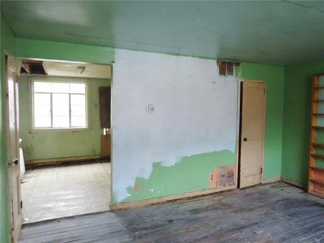 a view of an empty room and wooden floor
