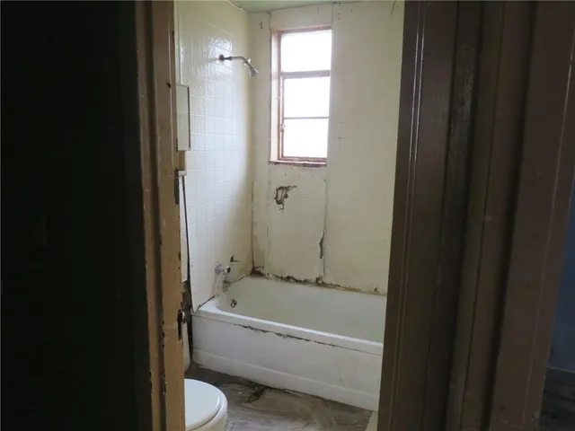 a bathroom with a tub and shower