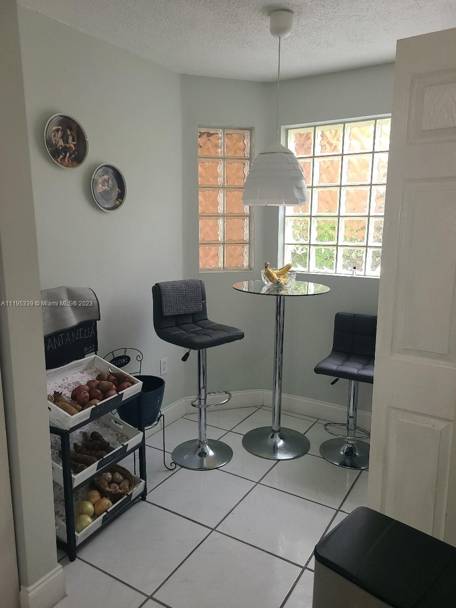 10030 Hammocks Boulevard, Unit 101 Miami, FL 33196 - Photo 17 of 27 a room with furniture and a window