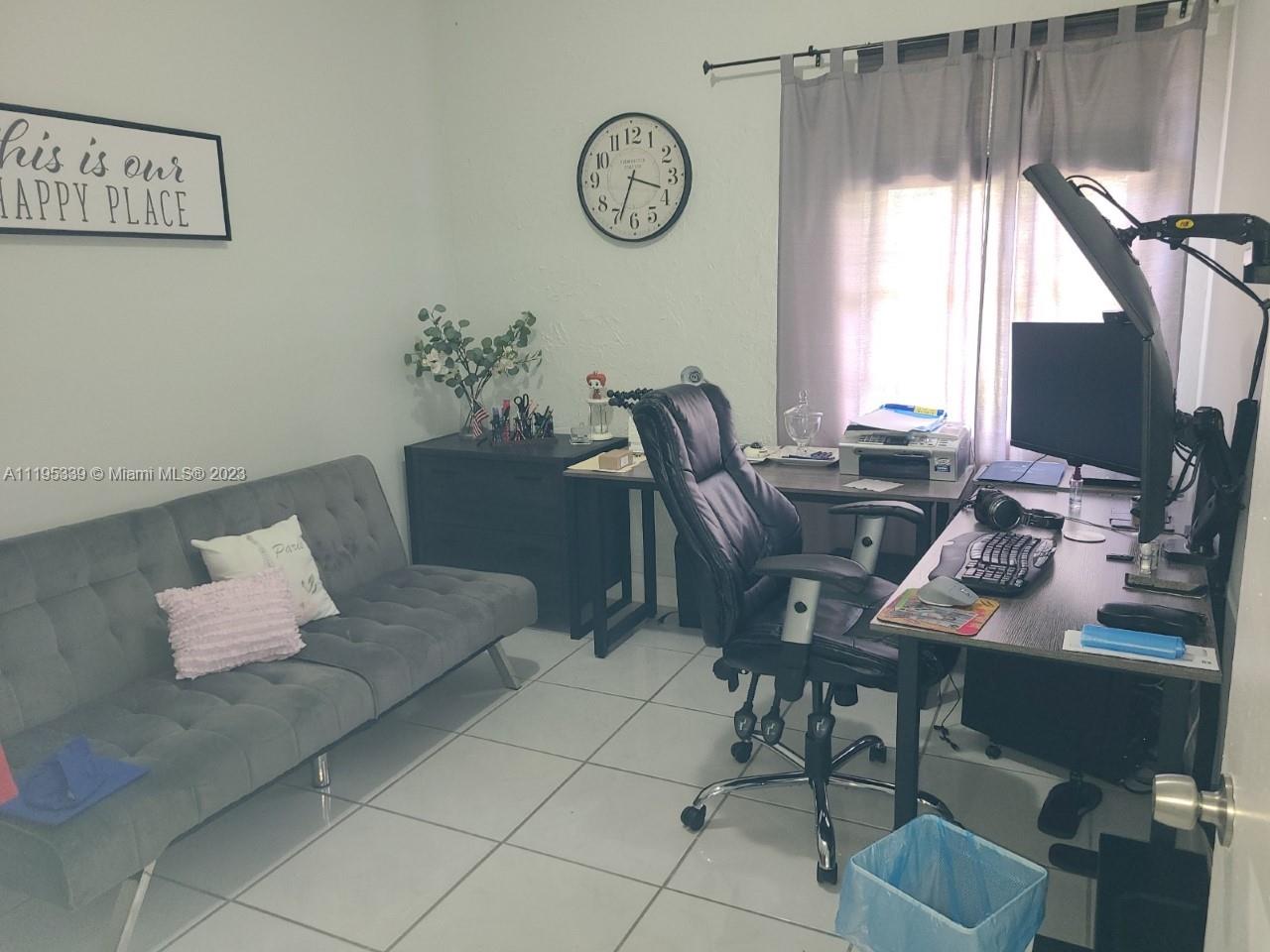 10030 Hammocks Boulevard, Unit 101 Miami, FL 33196 - Photo 19 of 27 a view of a workspace with furniture and a large window