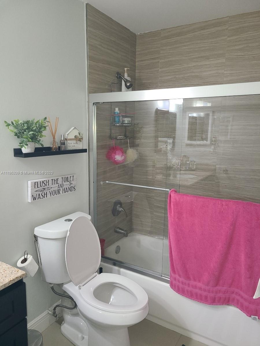10030 Hammocks Boulevard, Unit 101 Miami, FL 33196 - Photo 22 of 27 a bathroom with a toilet and a shower