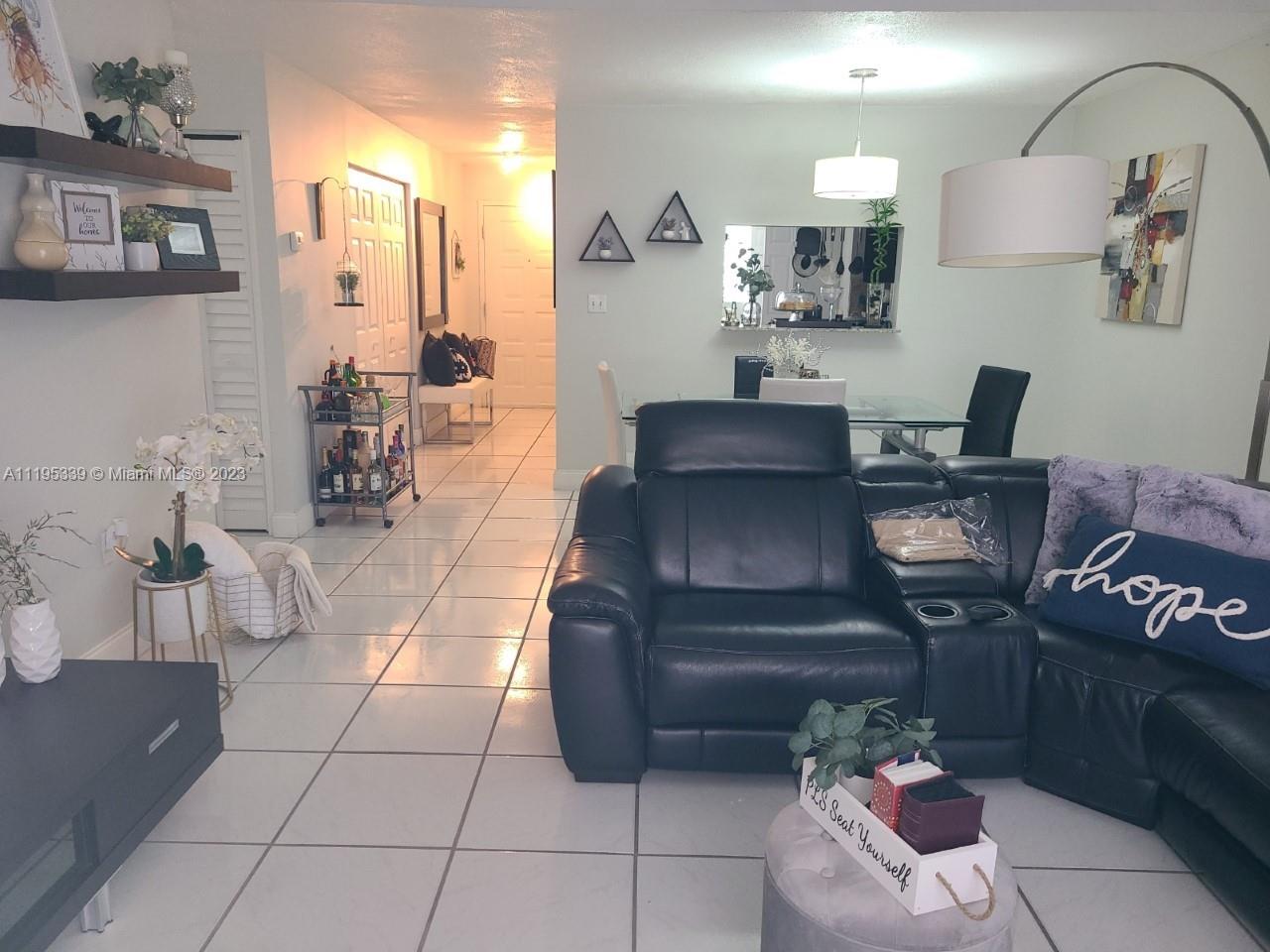 10030 Hammocks Boulevard, Unit 101 Miami, FL 33196 - Photo 27 of 27 a living room with furniture