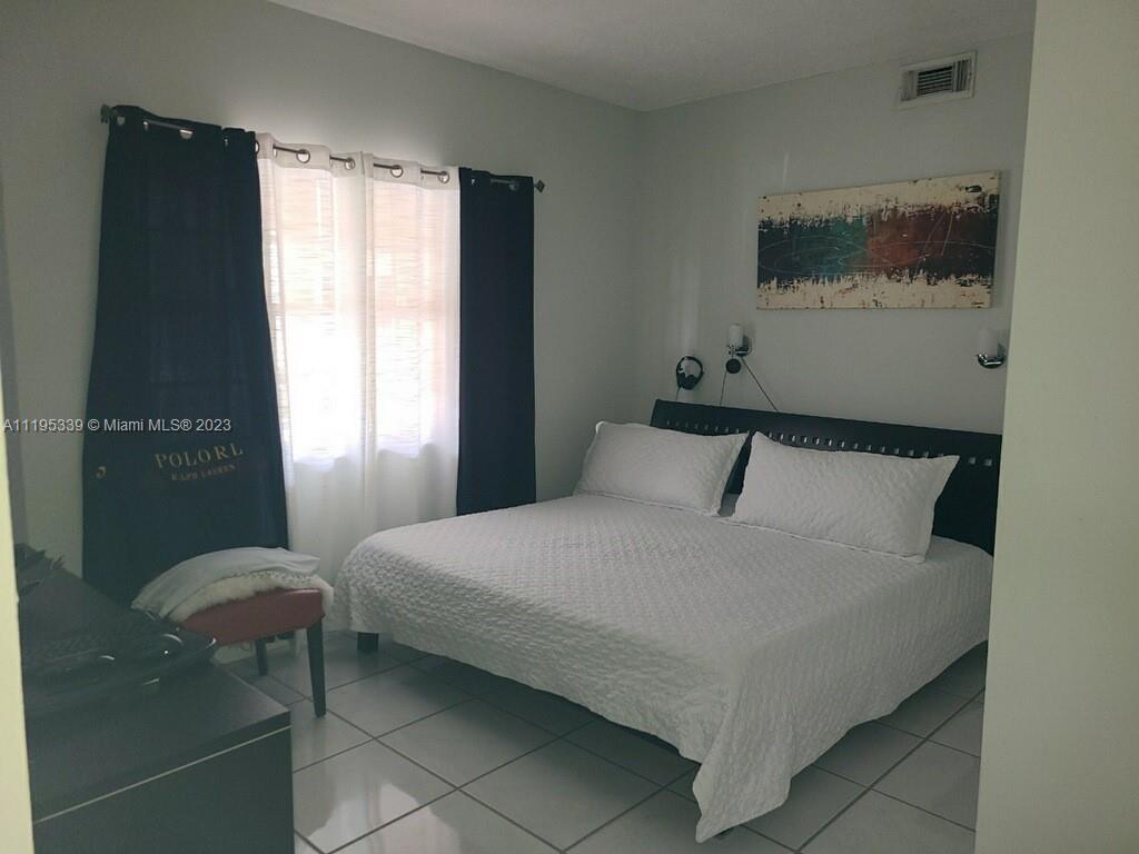 10030 Hammocks Boulevard, Unit 101 Miami, FL 33196 - Photo 3 of 27 a bedroom with a bed and window
