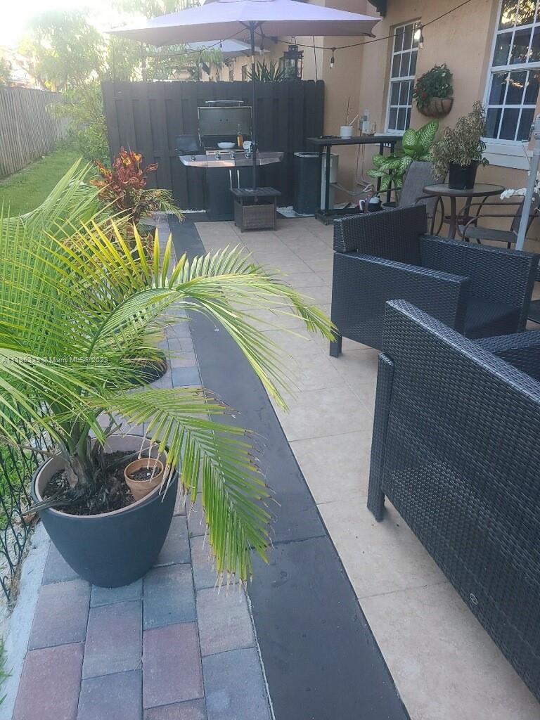 10030 Hammocks Boulevard, Unit 101 Miami, FL 33196 - Photo 7 of 27 a view of a swimming pool with a patio