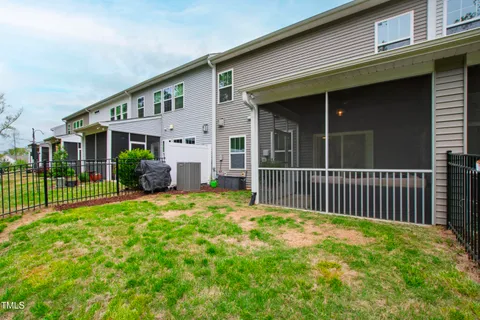 a view of a house with backyard and porch