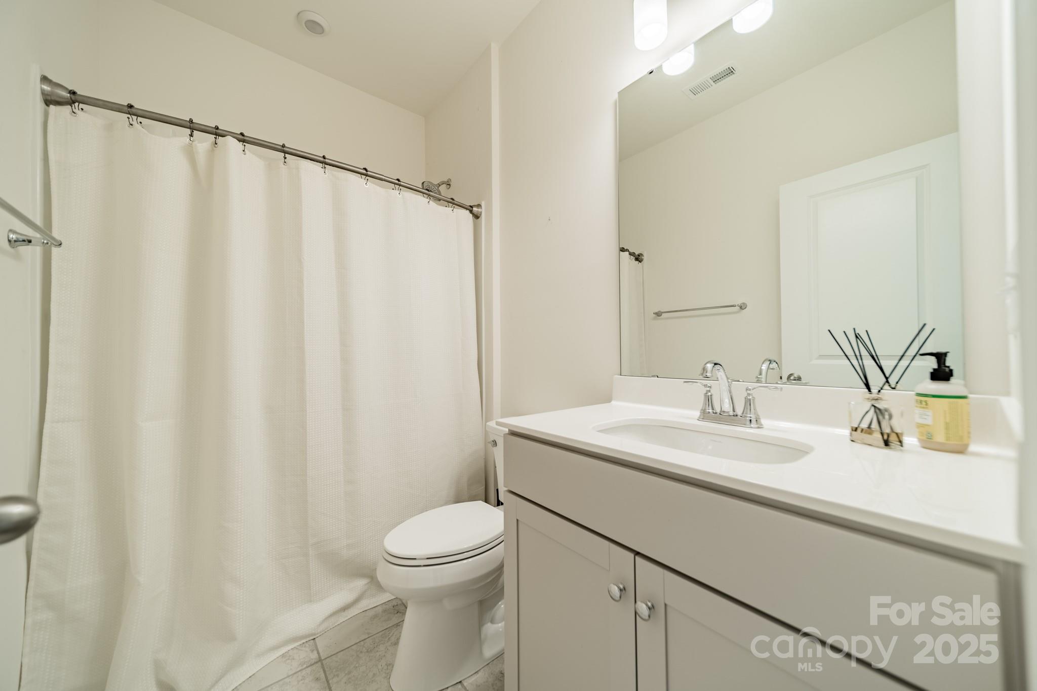 558 Red Wolf Lane Clover, SC 29710 - Photo 12 of 19 a bathroom with a sink a toilet and shower curtain