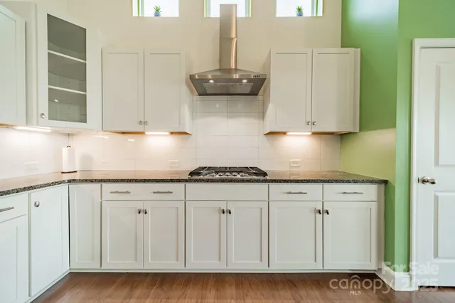a kitchen with granite countertop cabinets and white appliances