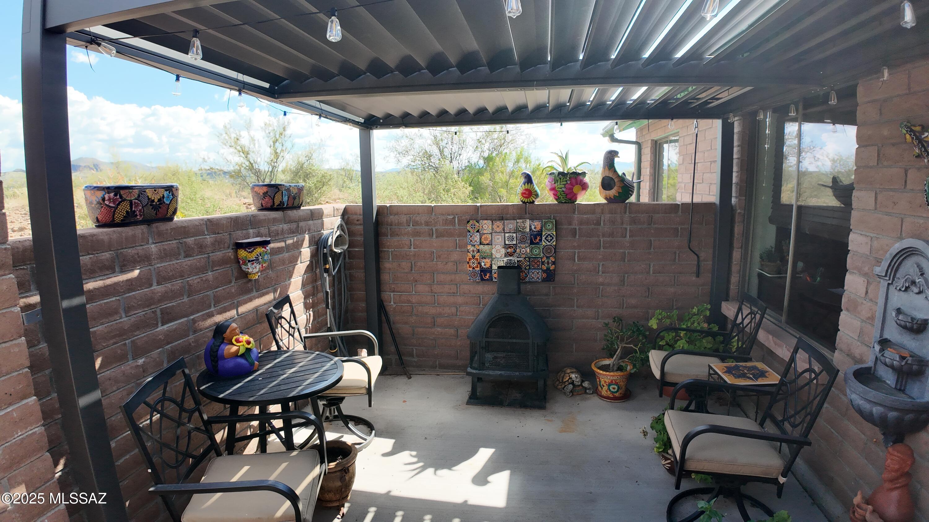 995 Jar Court Rio Rico, AZ 85648 - Photo 5 of 44 a outdoor living space with patio furniture and a fireplace