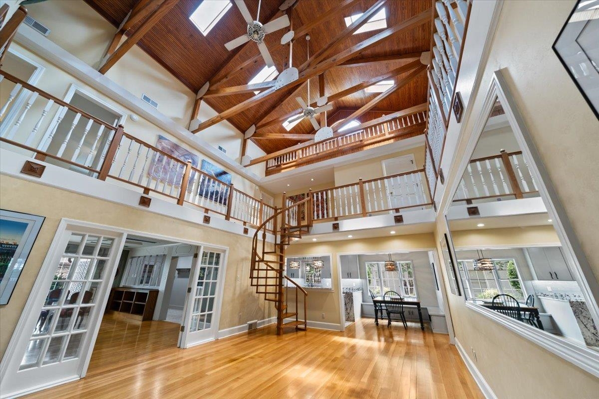 1095 Fair Meadow Road Memphis, TN 38117 - Photo 20 of 40 Living area with high vaulted ceiling, ceiling fan, stairway, wood finished floors, and a wooden ceiling with exposed beams