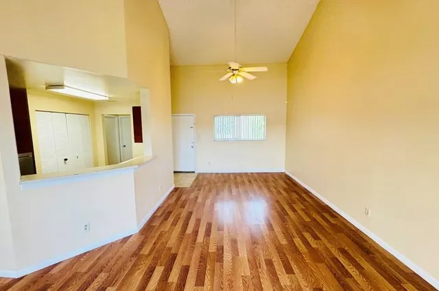 a view of a room with wooden floor and a bathroom
