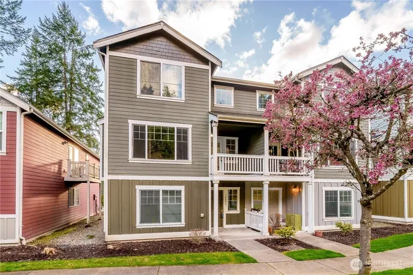 a front view of a house with garden and garage