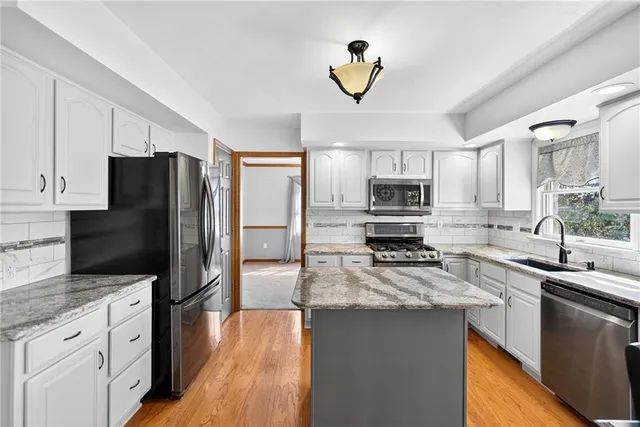 a kitchen with a refrigerator sink and microwave