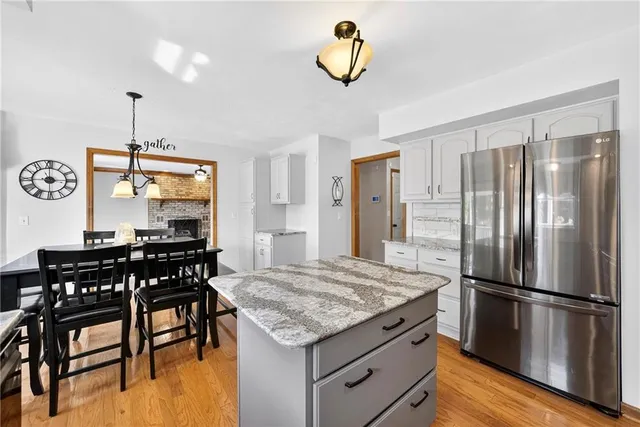 a kitchen with a table chairs and refrigerator