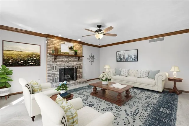 a living room with furniture fireplace and a large window
