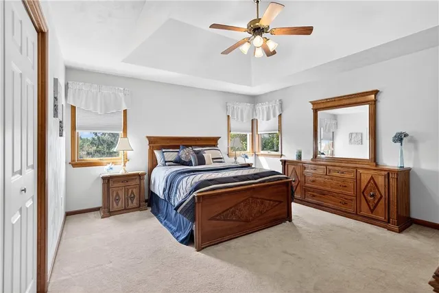 a bedroom with a large bed and a chandelier