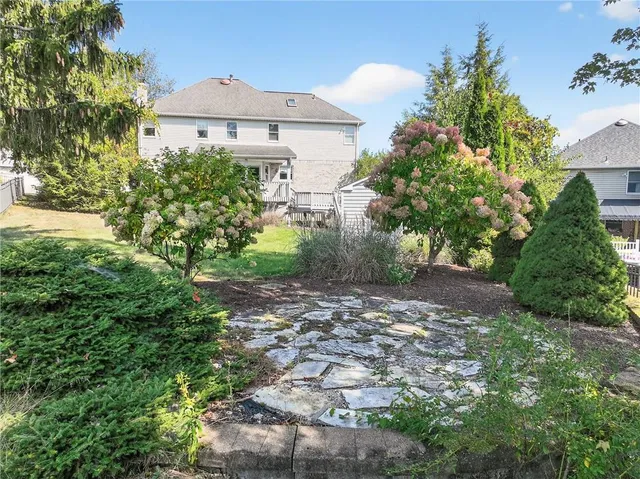 a view of a house with a yard and tree s