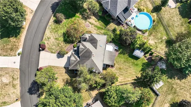 an aerial view of a house with a yard and garden