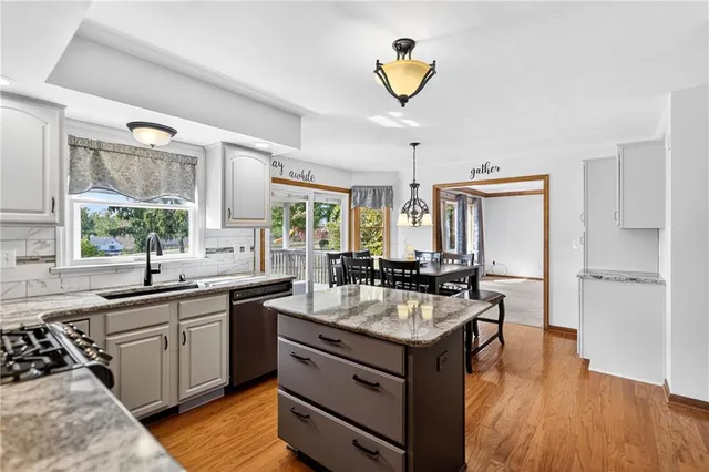 a kitchen with a sink stove and cabinets
