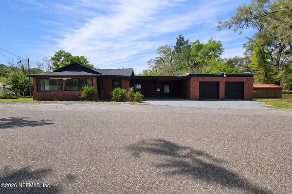 a front view of house with yard and trees