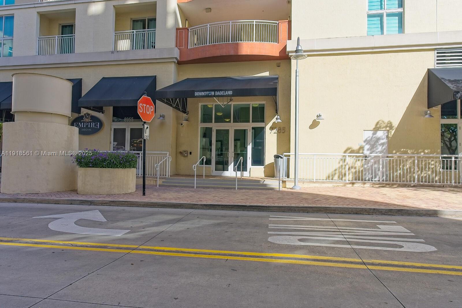 7285 Southwest 90th Street, Unit D613 Miami, FL 33156 - Photo 18 of 20 a view of a house with a small yard and large window and potted plants