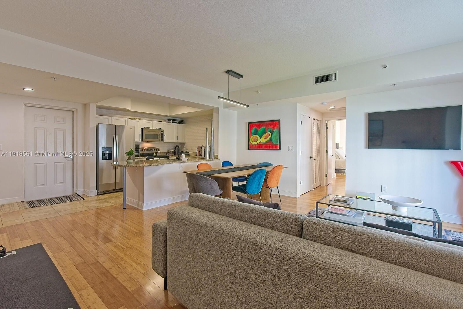 7285 Southwest 90th Street, Unit D613 Miami, FL 33156 - Photo 4 of 20 a living room with furniture and a flat screen tv