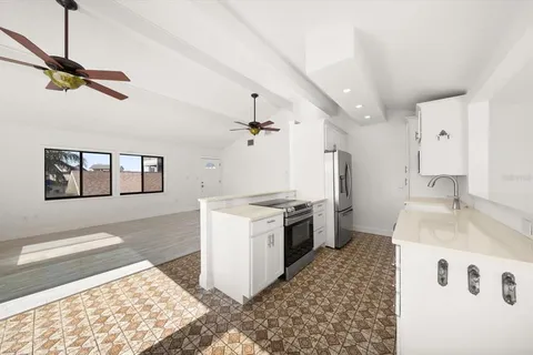 a kitchen with granite countertop a sink and a stove top oven