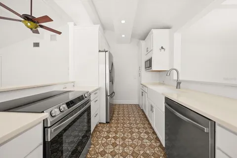 a kitchen with a sink appliances and cabinets