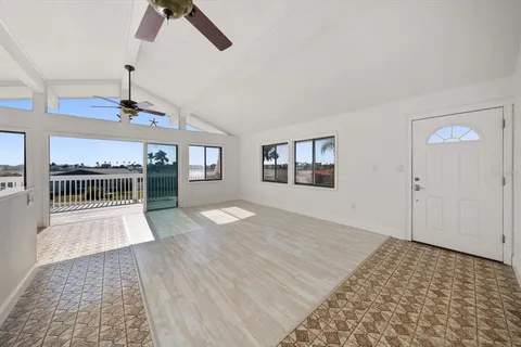 a view of empty room with wooden floor and window