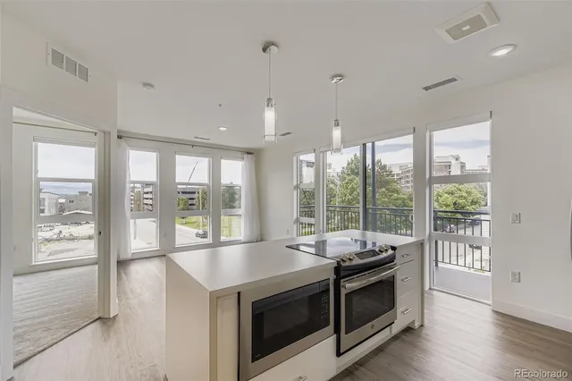 a view of a kitchen and microwave and stove