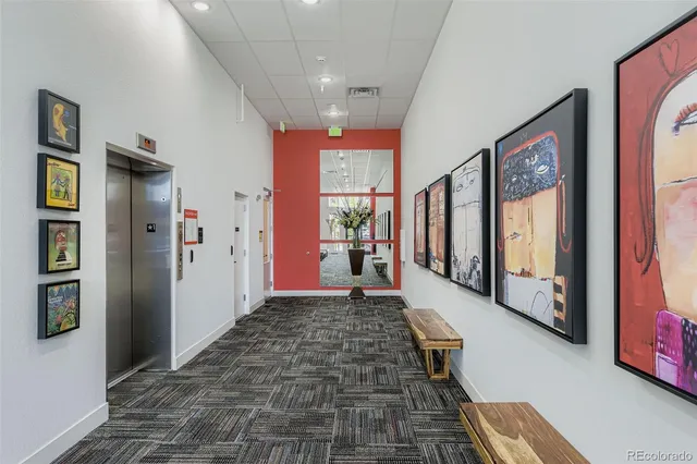 a hallway with beautiful frames and window